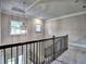 View of the staircase showcasing a modern chandelier, neutral walls, and dark wood railing at 3730 Reserve Overlook (Lot 8) Way, Cumming, GA 30041