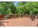 Spacious back deck with wood railing, greenery and nature views, ideal for outdoor relaxation at 734 Kilkenny Cir, Lithonia, GA 30058