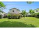 Lush backyard with green grass, mature trees, and a deck perfect for enjoying outdoor living at 734 Kilkenny Cir, Lithonia, GA 30058