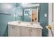 The bathroom features a double sink vanity with quartz countertops, and blue colored walls at 734 Kilkenny Cir, Lithonia, GA 30058