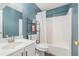 Bathroom with blue walls featuring white sink, toilet and bathtub at 734 Kilkenny Cir, Lithonia, GA 30058