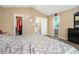 Bedroom with wood floors and access to the closet and ensuite bathroom, is tastefully decorated at 734 Kilkenny Cir, Lithonia, GA 30058