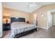 A bedroom with wood floors featuring a queen bed, a ceiling fan, and an adjacent night stand at 734 Kilkenny Cir, Lithonia, GA 30058