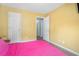 Bedroom featuring yellow walls, neutral flooring, and bright natural light at 734 Kilkenny Cir, Lithonia, GA 30058