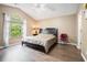 Bedroom featuring wood floors, a large window, a ceiling fan, and a queen size bed at 734 Kilkenny Cir, Lithonia, GA 30058