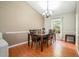 Formal dining room with wood floors, neutral walls, vaulted ceilings, and a chandelier at 734 Kilkenny Cir, Lithonia, GA 30058