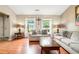Comfortable living room features wood floors, neutral walls, and plentiful natural light through large windows at 734 Kilkenny Cir, Lithonia, GA 30058