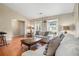 Comfortable living room features wood floors, neutral walls, and plentiful natural light through large windows at 734 Kilkenny Cir, Lithonia, GA 30058