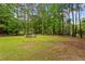 Expansive backyard featuring mature trees and fire pit at 836 Palmetto Tyrone Rd, Sharpsburg, GA 30277