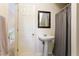 Compact bathroom with a pedestal sink, mirror, and a shower with a curtain at 836 Palmetto Tyrone Rd, Sharpsburg, GA 30277