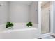 Bright bathroom features a tub with tile surround and a glass-enclosed shower at 836 Palmetto Tyrone Rd, Sharpsburg, GA 30277