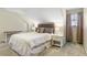 Cozy bedroom features a comfortable bed, a window, and a side table at 836 Palmetto Tyrone Rd, Sharpsburg, GA 30277