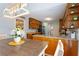 Stylish dining space adjacent to the kitchen with designer lighting and seating at 836 Palmetto Tyrone Rd, Sharpsburg, GA 30277