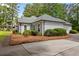 Well-maintained house with a side entry garage, complimented by green shrubbery at 836 Palmetto Tyrone Rd, Sharpsburg, GA 30277