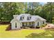 Stunning single-story home surrounded by mature trees, featuring a lush green lawn and beautiful landscaping at 836 Palmetto Tyrone Rd, Sharpsburg, GA 30277