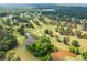 Scenic aerial view of a golf course with lush greenery, water features, and well-manicured greens at 836 Palmetto Tyrone Rd, Sharpsburg, GA 30277