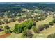 Expansive golf course aerial view featuring mature trees, rolling greens, and sand bunkers at 836 Palmetto Tyrone Rd, Sharpsburg, GA 30277
