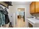 Laundry room with appliances, adjacent refrigerator and a view into the kitchen area at 836 Palmetto Tyrone Rd, Sharpsburg, GA 30277