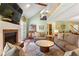 Open-concept living room boasting natural light, fireplace, and adjacent breakfast area at 836 Palmetto Tyrone Rd, Sharpsburg, GA 30277
