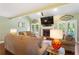 Inviting living room featuring a fireplace, vaulted ceilings, and access to the outdoors at 836 Palmetto Tyrone Rd, Sharpsburg, GA 30277