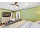 Bright main bedroom showcasing a ceiling fan, tray ceiling, and a dresser with a TV at 836 Palmetto Tyrone Rd, Sharpsburg, GA 30277
