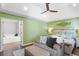 Spacious main bedroom featuring a tray ceiling, ceiling fan, and ensuite bathroom entrance at 836 Palmetto Tyrone Rd, Sharpsburg, GA 30277