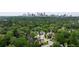 Aerial view of a lush neighborhood featuring mature trees and a cityscape backdrop at 1849 Rock Springs Ne Ln, Atlanta, GA 30324