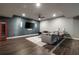 Finished basement with a large tv, a sofa and a red Coca-Cola themed refrigerator at 1849 Rock Springs Ne Ln, Atlanta, GA 30324