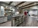 Basement bar featuring a sink, a beverage fridge, counter seating and exposed wood beams on the ceiling at 1849 Rock Springs Ne Ln, Atlanta, GA 30324