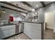 Basement bar with a dishwasher, stainless steel sink, and bar seating with exposed wood beams on ceiling at 1849 Rock Springs Ne Ln, Atlanta, GA 30324