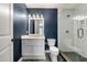 Bathroom featuring navy walls, glass shower and white vanity at 1849 Rock Springs Ne Ln, Atlanta, GA 30324