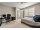 Bedroom featuring carpet, grey walls, a workspace, and a peek into the bathroom at 1849 Rock Springs Ne Ln, Atlanta, GA 30324