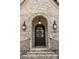 Arched front door with decorative wreath and updated exterior lighting at 1849 Rock Springs Ne Ln, Atlanta, GA 30324