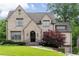 Charming brick home featuring manicured lawn, arched entry, and attached two-car garage at 1849 Rock Springs Ne Ln, Atlanta, GA 30324