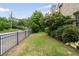 Well-manicured front yard with a black metal fence, lush greenery, and mature trees along the street at 1849 Rock Springs Ne Ln, Atlanta, GA 30324