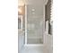 Glass enclosed shower with white subway tile and rain shower head at 1849 Rock Springs Ne Ln, Atlanta, GA 30324