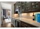 Wet bar area with wine fridge, granite countertop, and glass shelving at 1849 Rock Springs Ne Ln, Atlanta, GA 30324