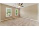 Neutral-toned bedroom featuring plush carpet, ample natural light, and a ceiling fan at 2154 Marne Nw Gln, Kennesaw, GA 30152