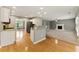 Well-lit kitchen featuring wood floors, granite countertops, and modern appliances at 2154 Marne Nw Gln, Kennesaw, GA 30152