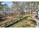 Grassy backyard of home with a tree line and views of the covered patio at 2401 Phillips Rd, Lithonia, GA 30058