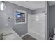 Bathroom with tub-shower combo, large window, and neutral color scheme at 2401 Phillips Rd, Lithonia, GA 30058