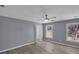 Bright bedroom features two windows, a ceiling fan, and light wood flooring at 2401 Phillips Rd, Lithonia, GA 30058