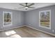 Comfortable bedroom with natural light, ceiling fan, and wood-look floors at 2401 Phillips Rd, Lithonia, GA 30058