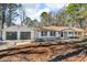 Charming ranch-style home featuring a two-car garage and well-maintained front yard at 2401 Phillips Rd, Lithonia, GA 30058