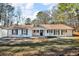 Well-maintained ranch home boasting new white siding and manicured landscaping at 2401 Phillips Rd, Lithonia, GA 30058