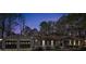 Exterior of a home at night with two-car garage and manicured landscaping at 2401 Phillips Rd, Lithonia, GA 30058
