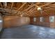 Spacious garage with exposed beams, painted floor, and side windows at 2401 Phillips Rd, Lithonia, GA 30058