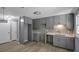 Modern kitchen featuring gray cabinets, tile backsplash, and bright lighting at 2401 Phillips Rd, Lithonia, GA 30058