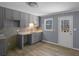 Modern kitchen featuring gray cabinets, tile backsplash, and bright lighting at 2401 Phillips Rd, Lithonia, GA 30058