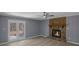 Inviting living room features a stone fireplace, a ceiling fan, and double doors to the outside at 2401 Phillips Rd, Lithonia, GA 30058